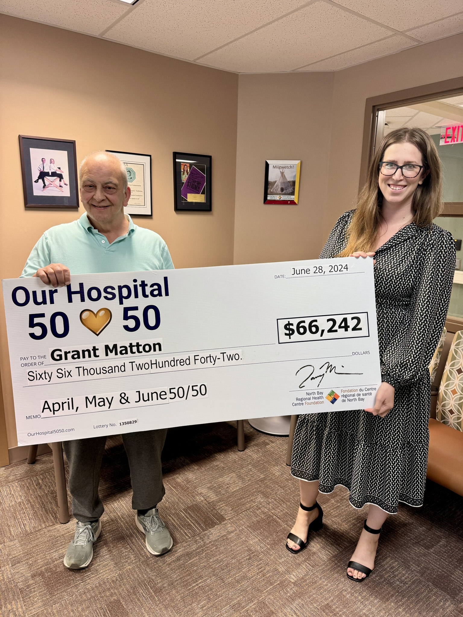 50/50 Winner Grant Matton standing with NBRHC Foundation Employee with oversized cheque. The cheque is for $66,242.